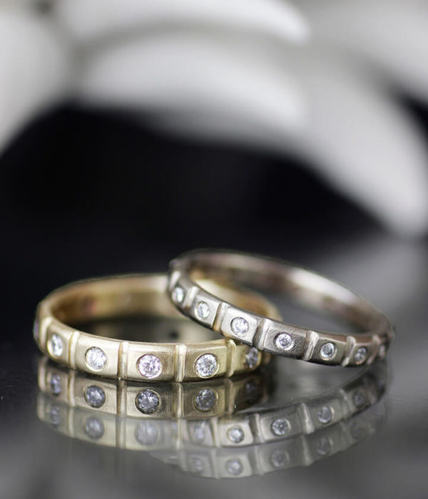 diamond studded crenelated bands in white gold and yellow gold