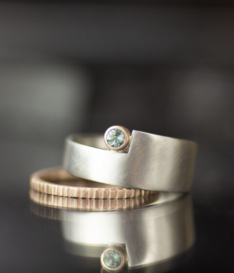 platinum and 14K rose gold mixed metals geo cut out alternative engagement ring with teal sapphire and textured wedding band 3