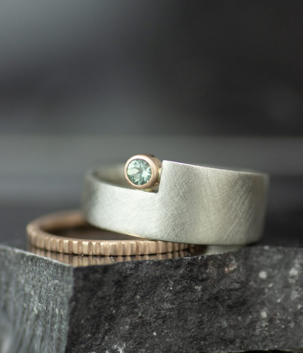 platinum and 14K rose gold mixed metals geo cut out alternative engagement ring with teal sapphire and textured wedding band 2
