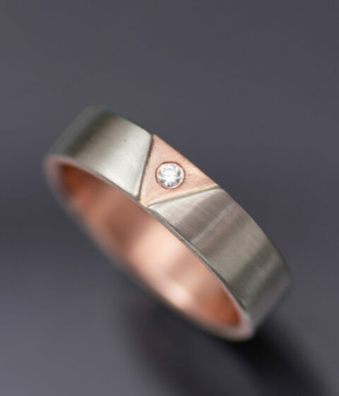 Pink triangle in rose gold on a white gold band. Diamond color corrected