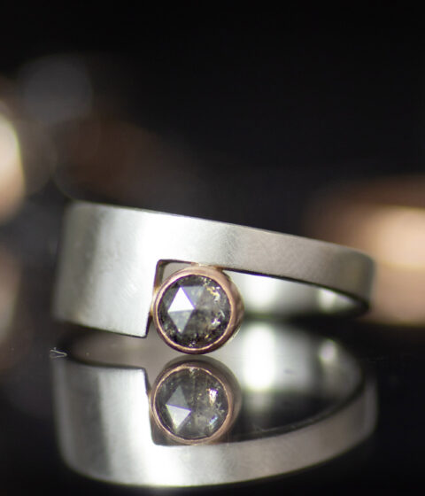 platinum and 14K rose gold non binary modern engagement ring with rose cut salt and pepper diamond