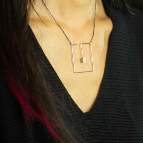box in a box necklace on model