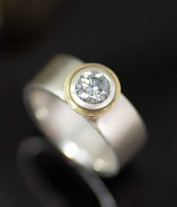 tessellated gray moissanite bezel set alt solitaire in platinum and 14K yellow gold scaled
