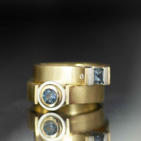 nonbinary engagement ring with Montana sapphire round and sqaure 14K yellow gold and platinum canyon set