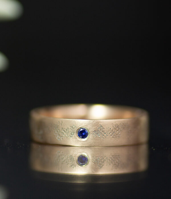 14K rose gold interstellar gender neutral wedding band with blue sapphire