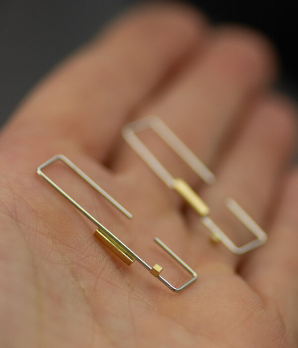 Gold And Platinum Rectangle Rectangle Threader Earrings On Hand Scaled